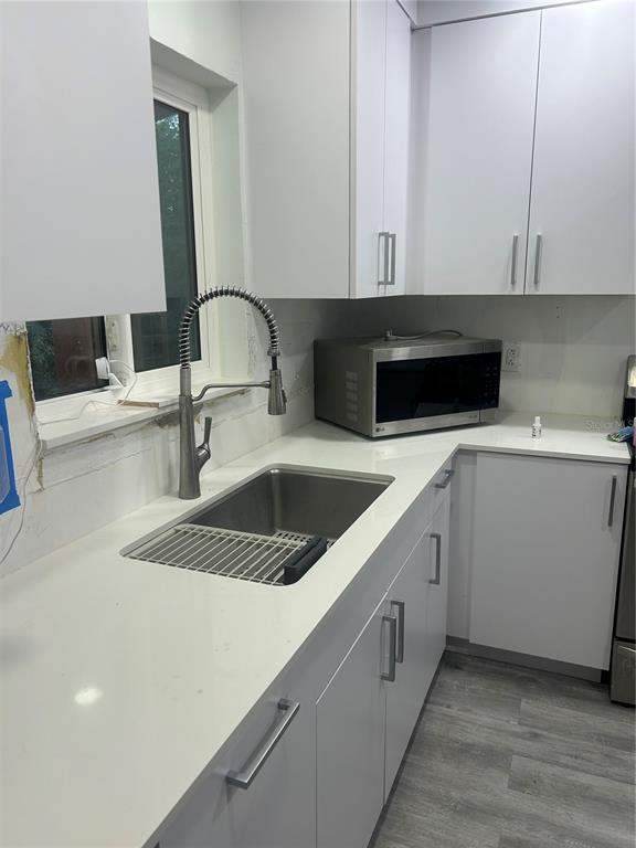 16705 Southwest 298th Terrace Homestead, FL 33030 - Photo 23 of 26 a kitchen with a sink and a stove top oven