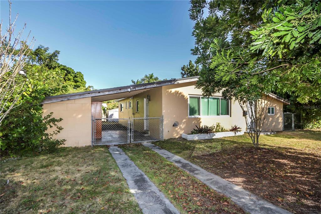 16705 Southwest 298th Terrace Homestead, FL 33030 - Photo 3 of 26 a front view of a house with a yard and garage