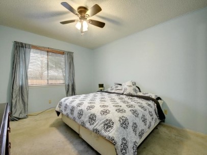 6601 Ripple Run Austin, TX 78744 - Photo 14 of 22 a bedroom with a bed and a window