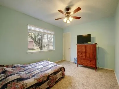 a bedroom with a bed and a television