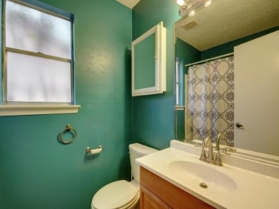 6601 Ripple Run Austin, TX 78744 - Photo 19 of 22 a bathroom with a toilet sink and mirror
