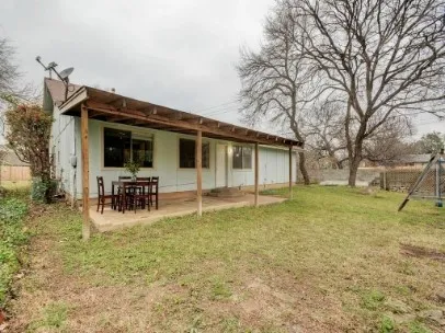 a view of a house with patio and a garden