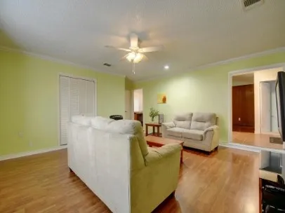 a living room with furniture and a wooden floor
