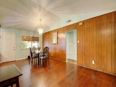 a dining room with furniture window and wooden floor