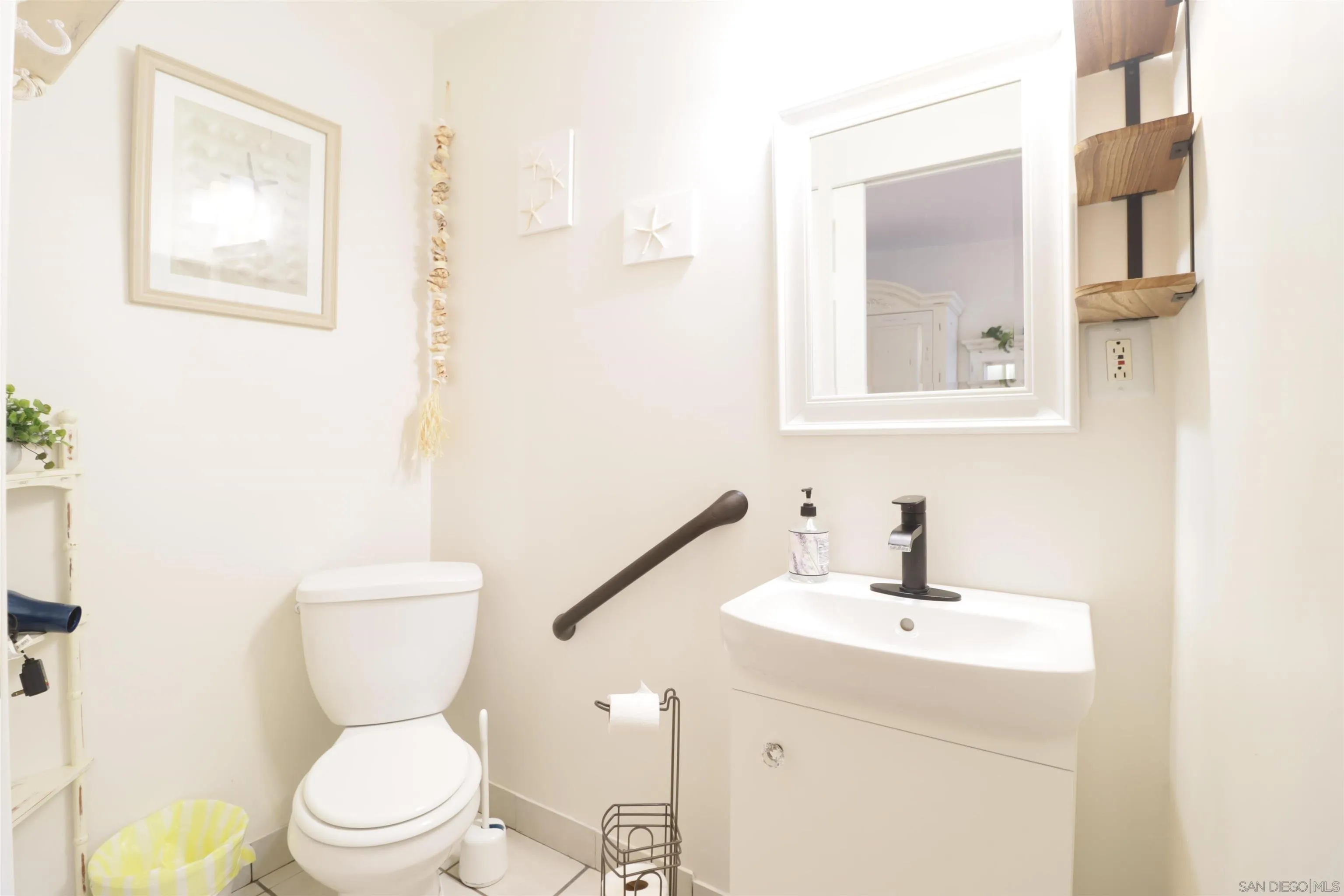 1233 Cresthill Road El Cajon, CA 92021 - Photo 14 of 50 a bathroom with a toilet a sink and mirror