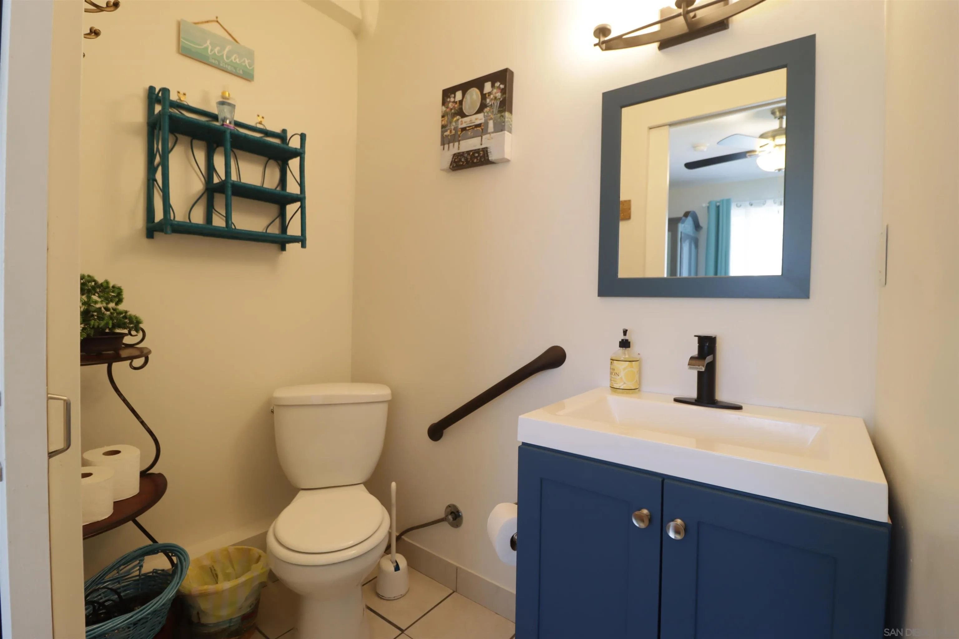 1233 Cresthill Road El Cajon, CA 92021 - Photo 23 of 50 a bathroom with a toilet sink and mirror