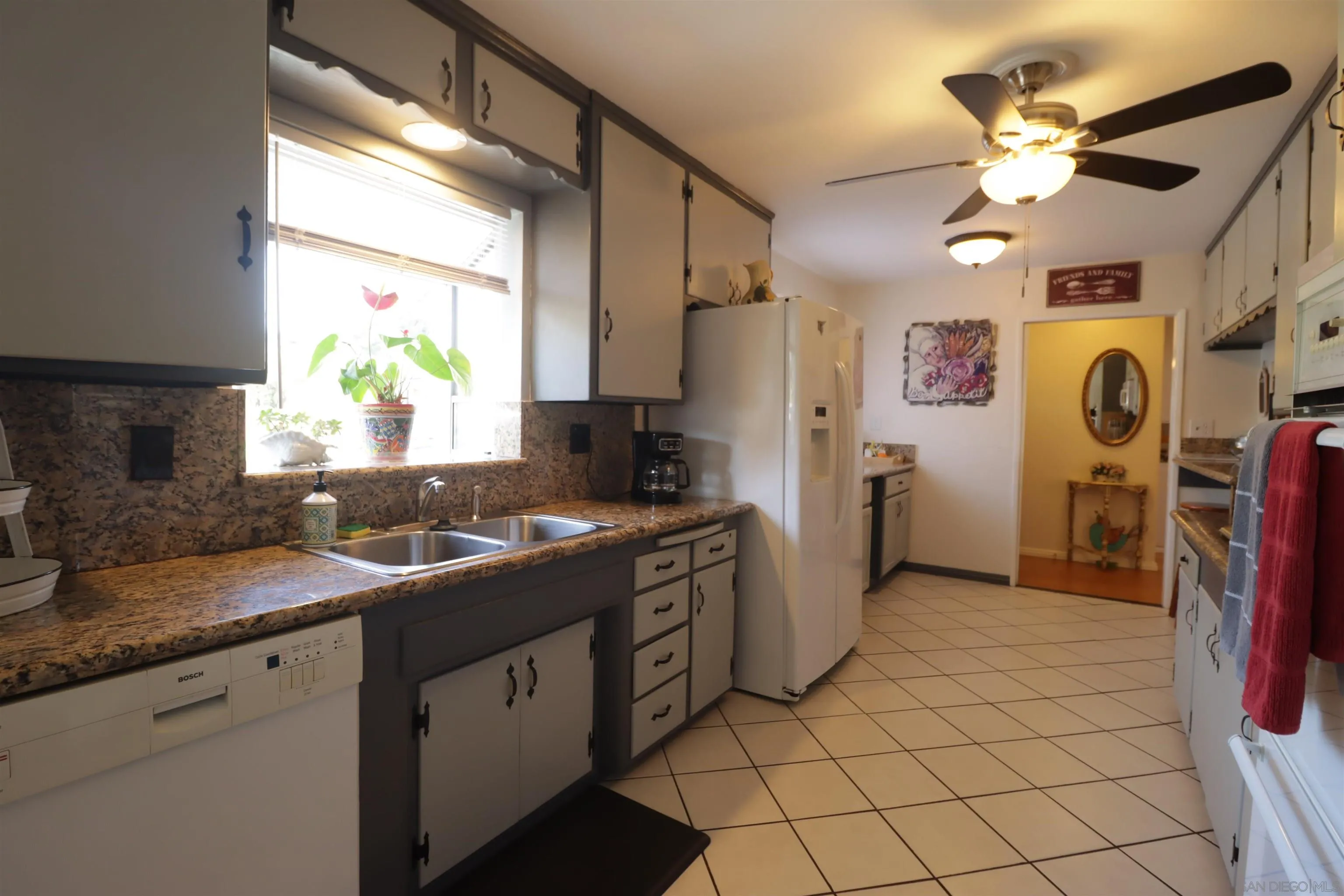 1233 Cresthill Road El Cajon, CA 92021 - Photo 28 of 50 a kitchen with stainless steel appliances granite countertop a sink a refrigerator and a granite counter tops