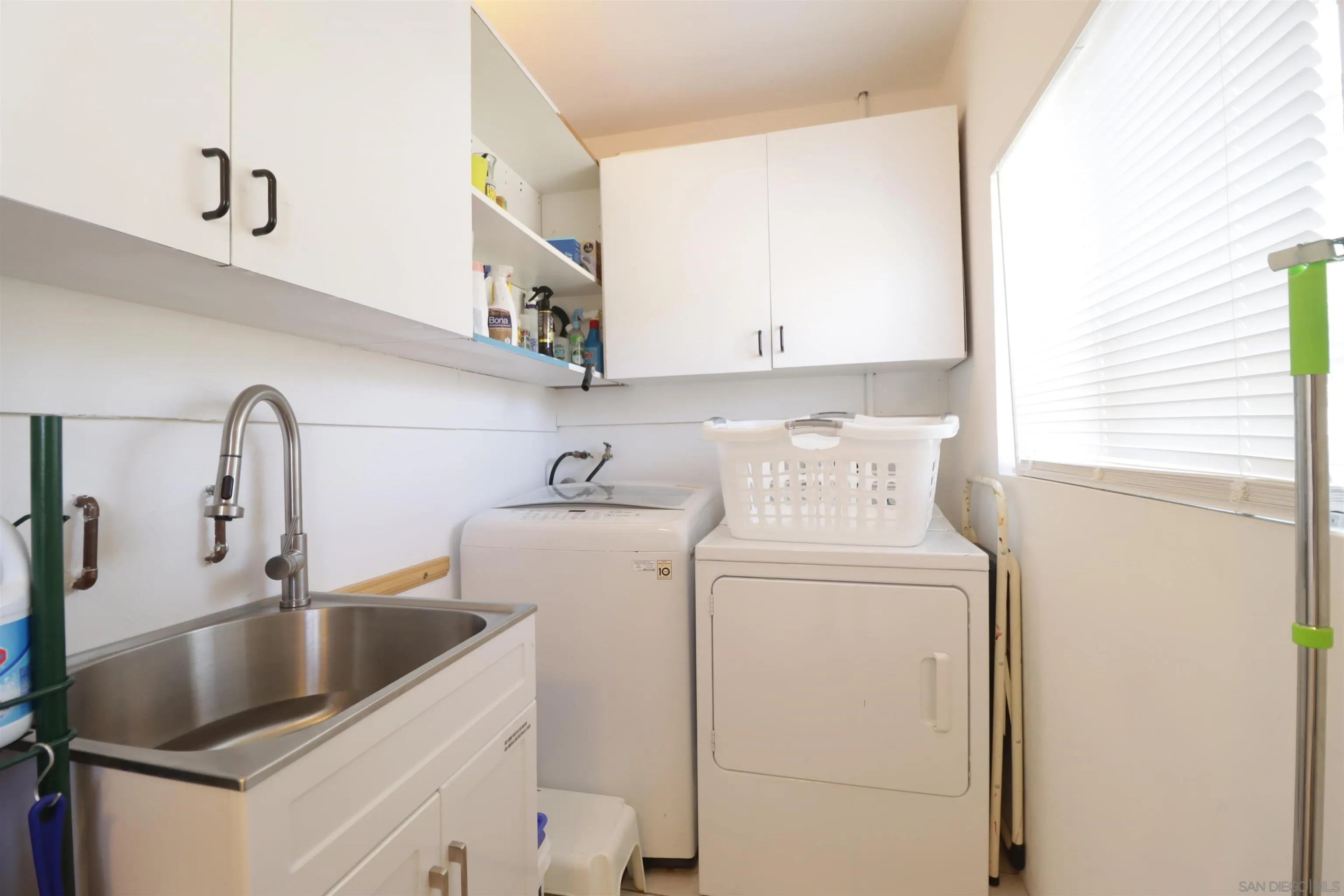 1233 Cresthill Road El Cajon, CA 92021 - Photo 33 of 50 a kitchen with a sink and a washer dryer