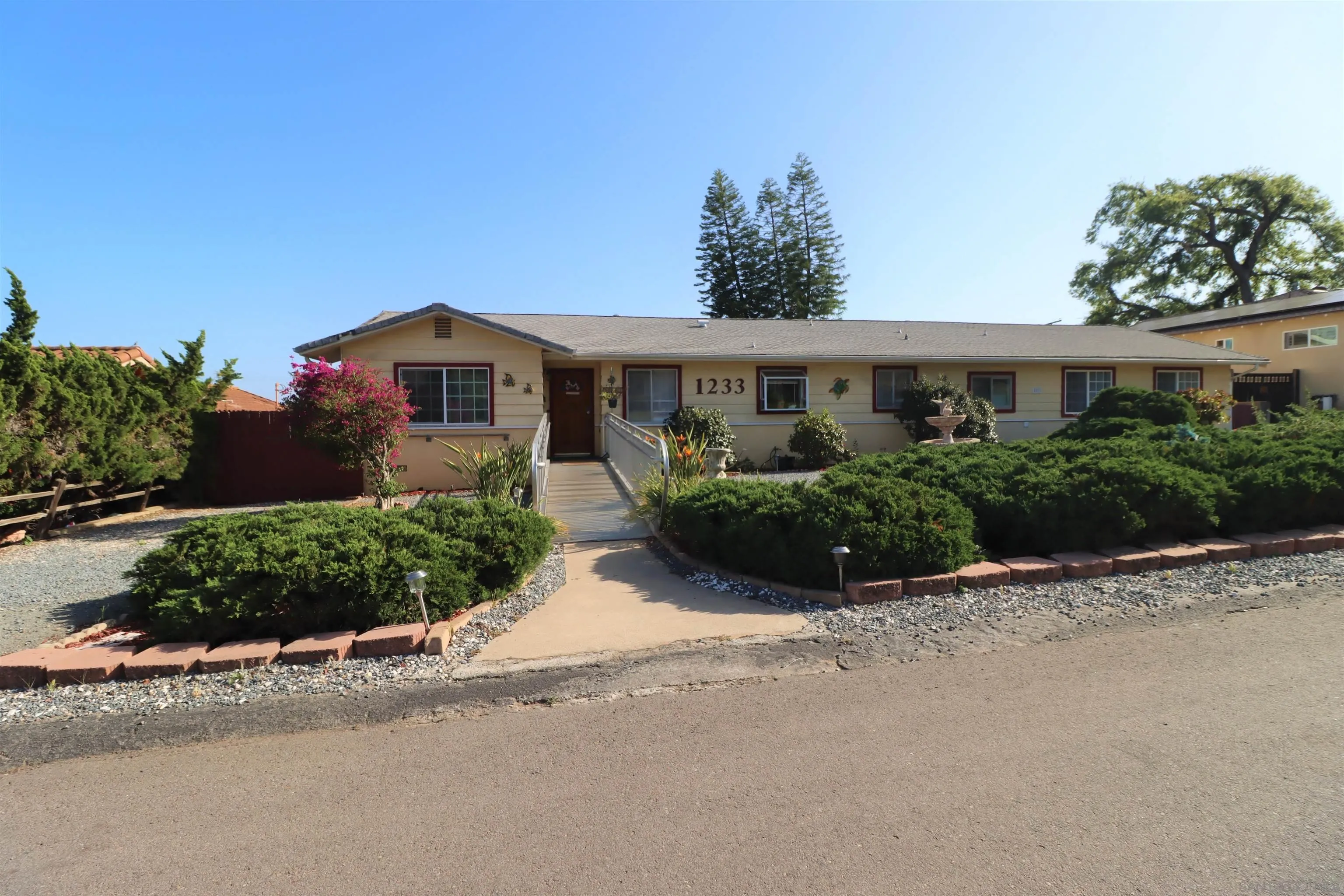 1233 Cresthill Road El Cajon, CA 92021 - Photo 4 of 50 a front view of a house with a garden and plants