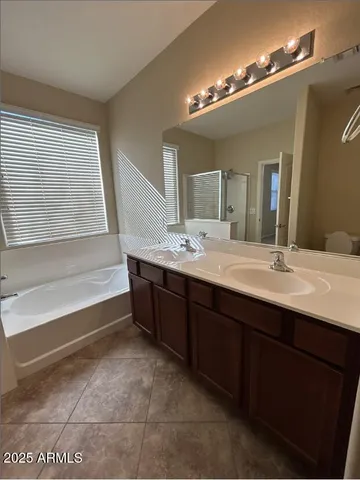 a bathroom with a sink a mirror and a bathtub