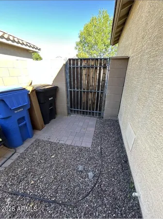 an empty room with a chandelier fan and mirror