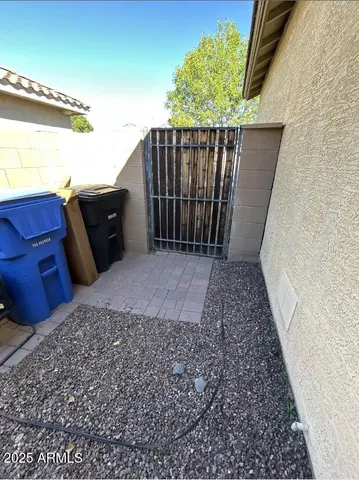 an empty room with a chandelier fan and mirror