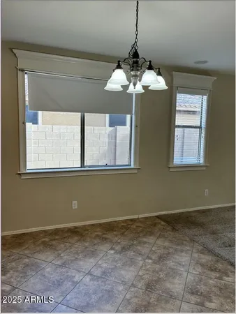 a view of an empty room with a fireplace and a window