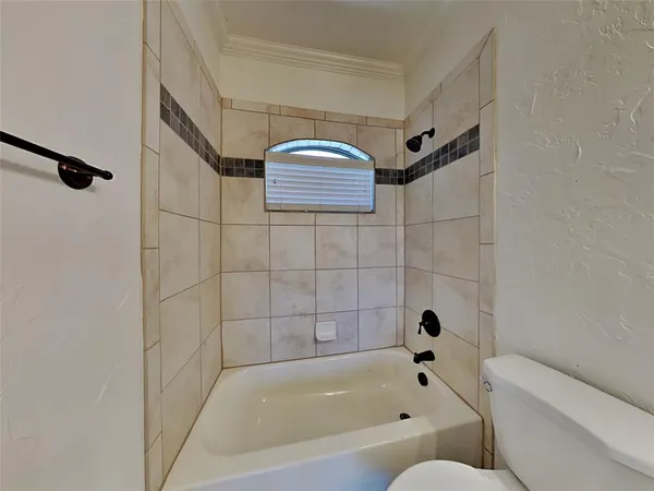 a bathroom with a bathtub and shower