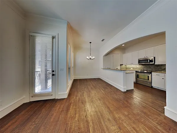 a view of kitchen with wooden floor and electronic appliances