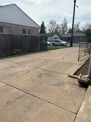 a building outdoor space with patio furniture and potted plants