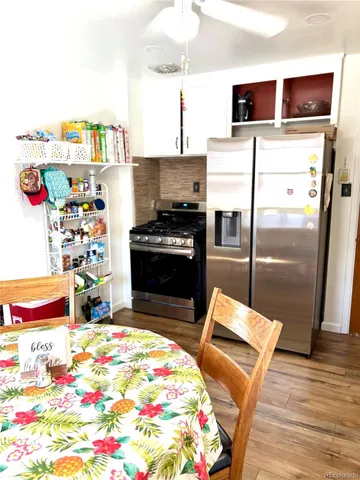 a kitchen with stainless steel appliances kitchen island granite countertop a refrigerator and a stove