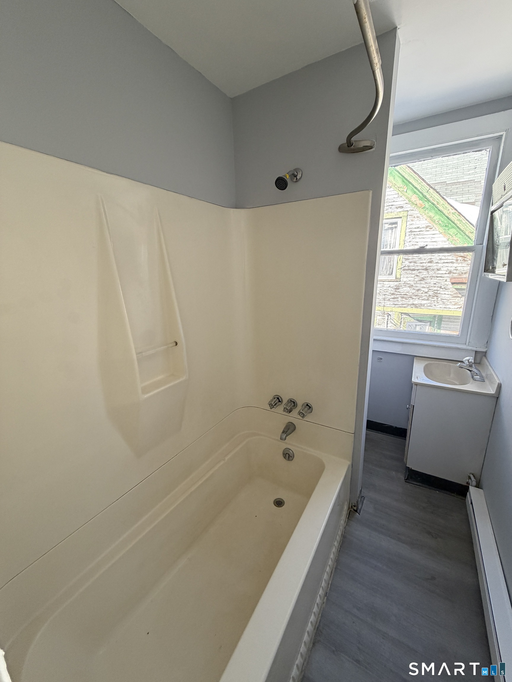 73 Waterville Street, Unit 3 Waterbury, CT 06710 - Photo 7 of 9 a bathroom with a bathtub and a window