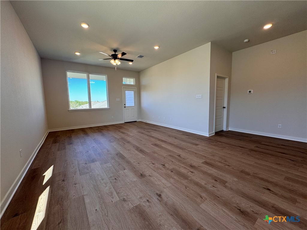 310 University Avenue Troy, TX 76579 - Photo 11 of 21 an empty room with wooden floor and windows