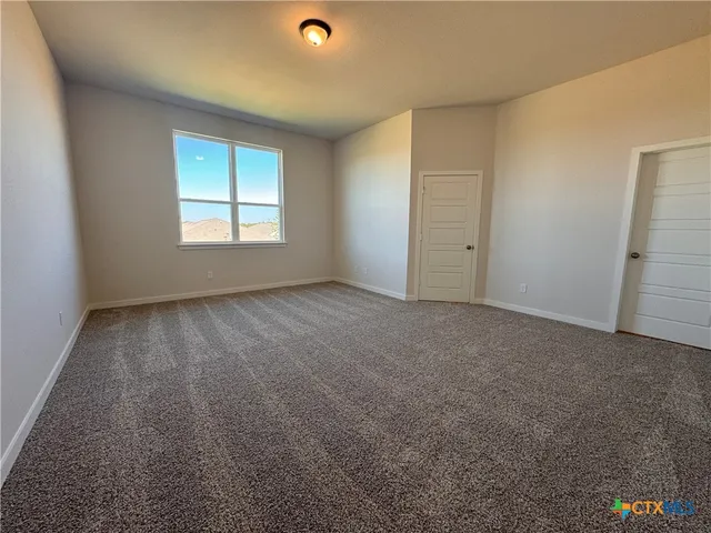 an empty room with a empty space and windows