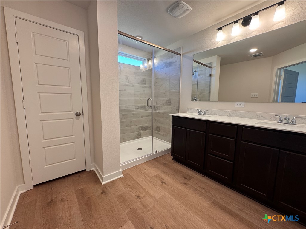 310 University Avenue Troy, TX 76579 - Photo 19 of 21 a spacious bathroom with a granite countertop sink mirror and shower