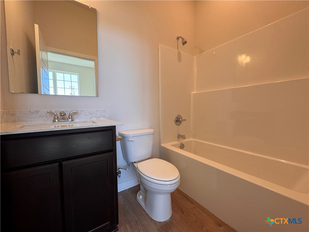 310 University Avenue Troy, TX 76579 - Photo 4 of 21 a bathroom with a sink a toilet and shower