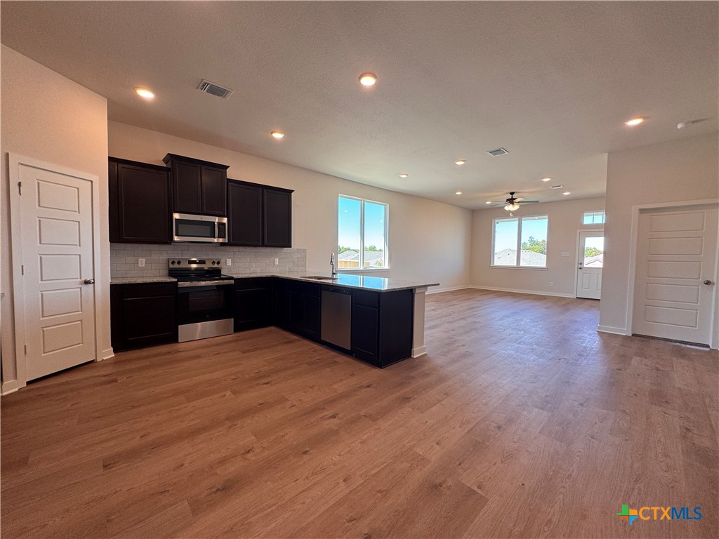 310 University Avenue Troy, TX 76579 - Photo 6 of 21 a large kitchen with stainless steel appliances granite countertop a large counter top a sink and a oven