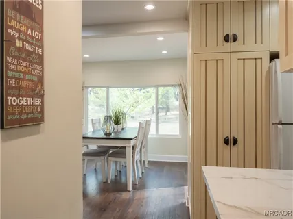 a dining room with furniture and wooden floor