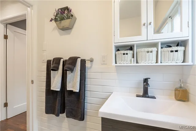 a bathroom with a sink and a mirror
