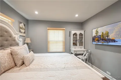 a bedroom with a large bed and a window