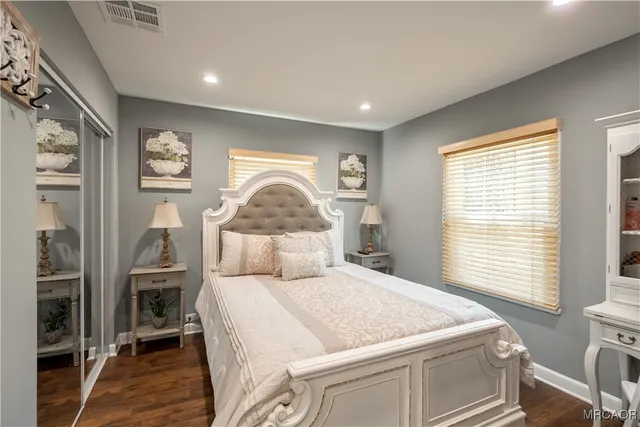 a bedroom with a large bed and a window