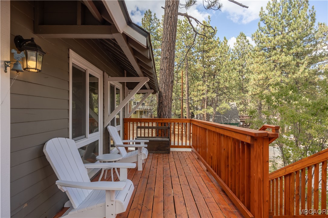 195 Elgin Road Big Bear Lake, CA 92315 - Photo 34 of 40 a view of balcony with wooden floor and outdoor seating