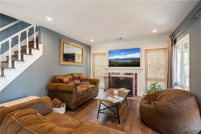 a living room with furniture fireplace and flat screen tv