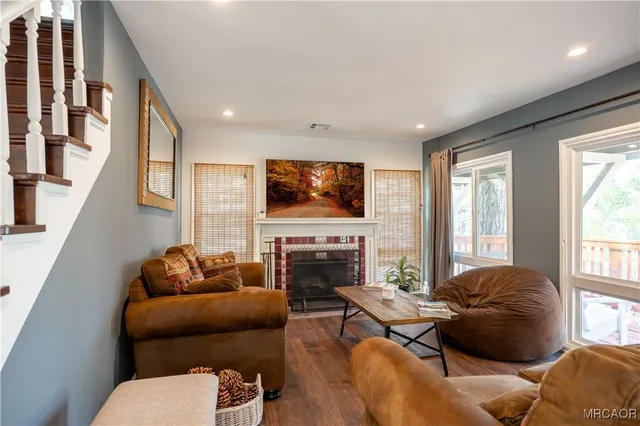 a living room with furniture flat screen tv and a fireplace