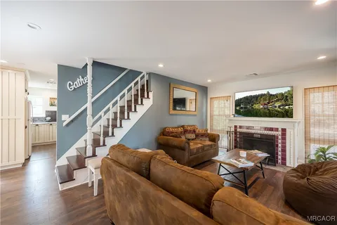 a living room with furniture flat screen tv and a fireplace