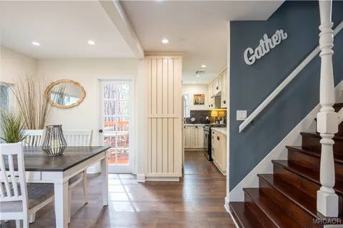 a view of entryway and hall with wooden floor