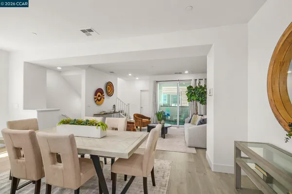 a large white kitchen with granite countertop a sink and white appliances