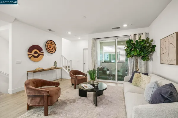 a kitchen with stainless steel appliances granite countertop white cabinets a sink and a oven