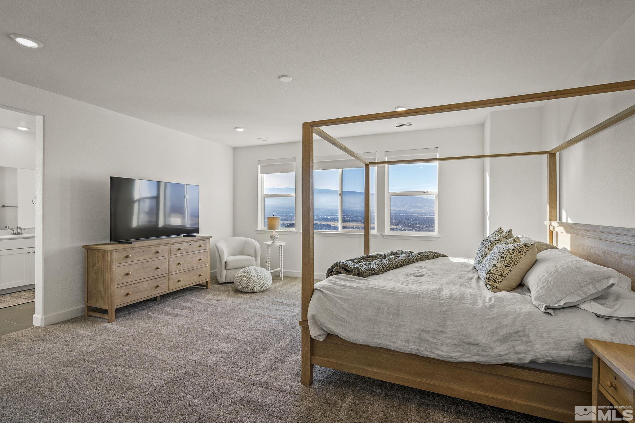 10489 Claim Jumper Way Reno, NV 89521 - Photo 18 of 40 a bedroom with a bed and large windows