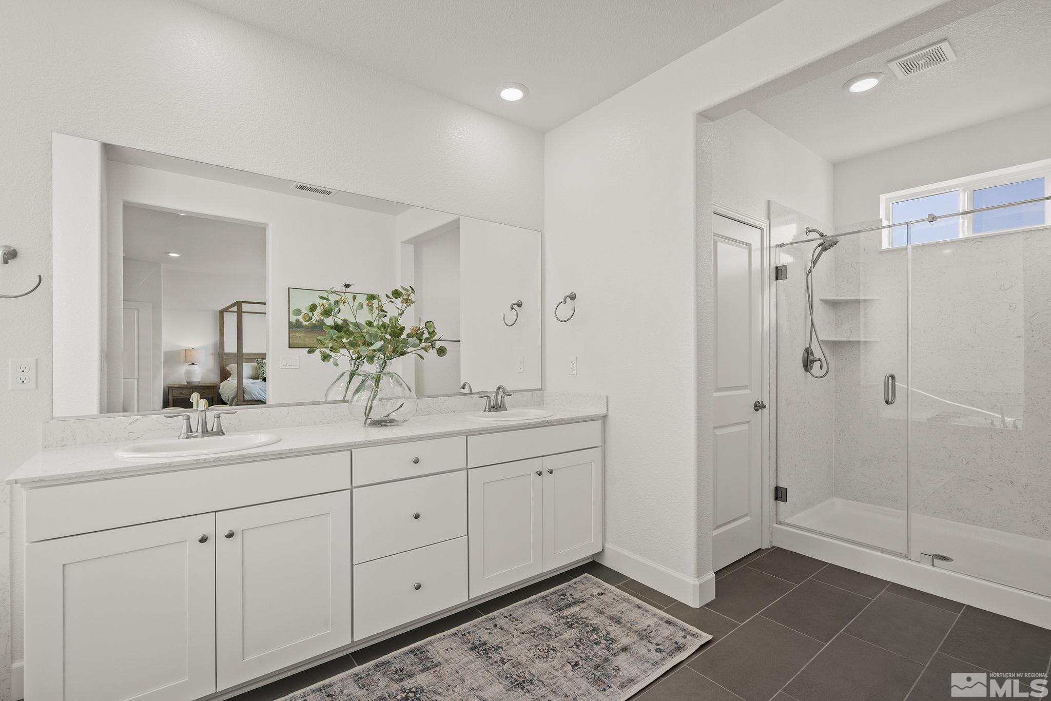 10489 Claim Jumper Way Reno, NV 89521 - Photo 20 of 40 a spacious bathroom with double sink and a mirror