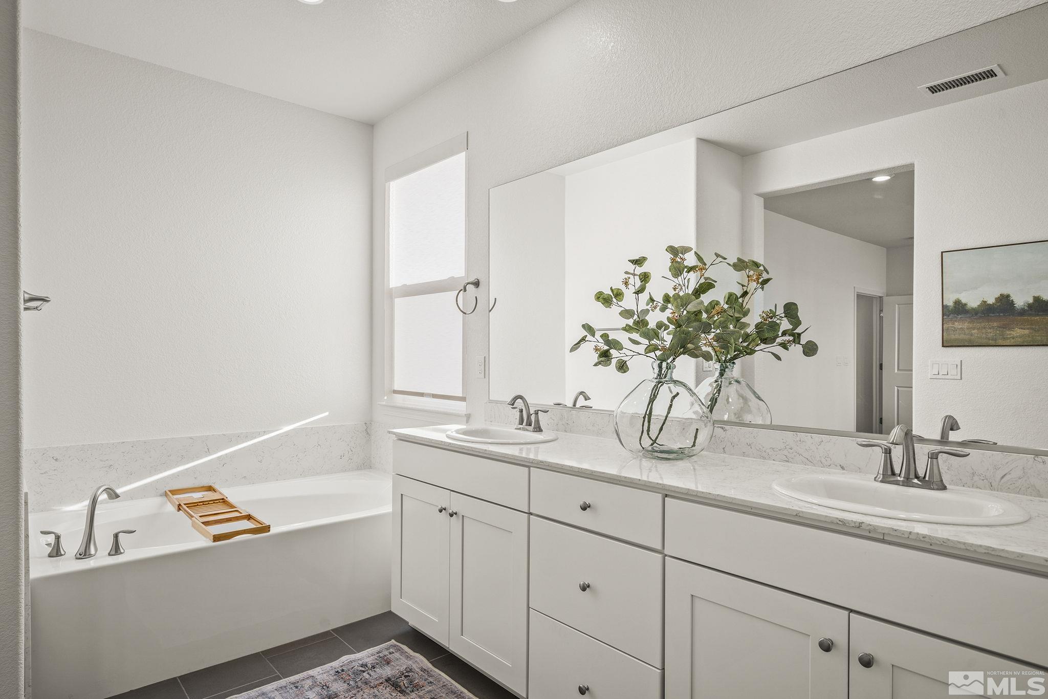 10489 Claim Jumper Way Reno, NV 89521 - Photo 21 of 40 a bathroom with a granite countertop sink and a mirror