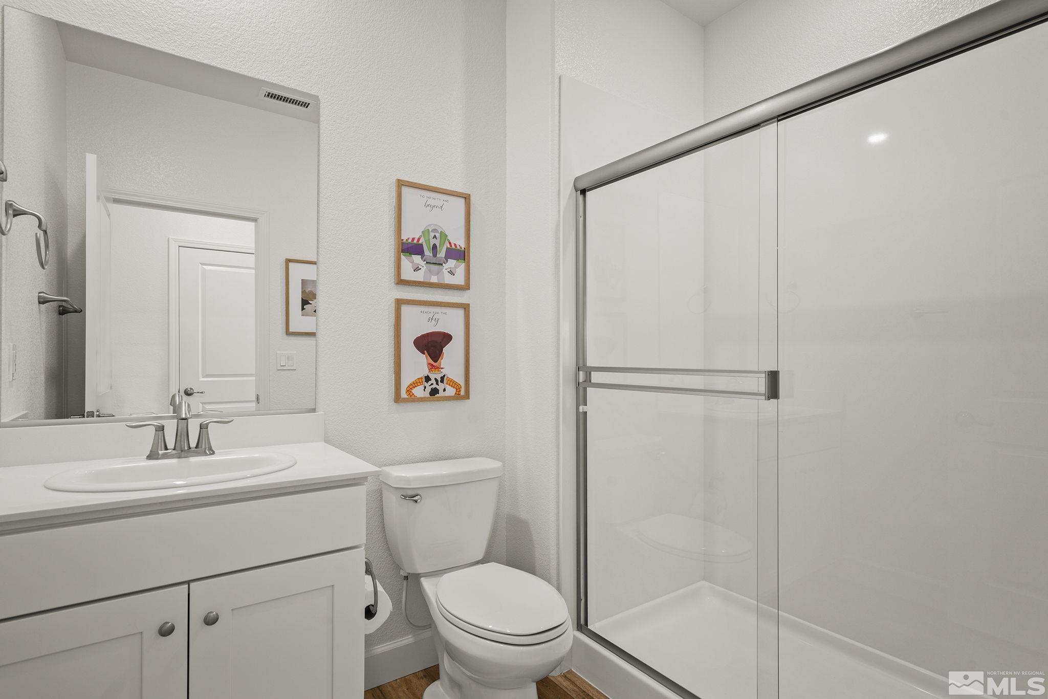 10489 Claim Jumper Way Reno, NV 89521 - Photo 23 of 40 a bathroom with a sink a toilet and shower