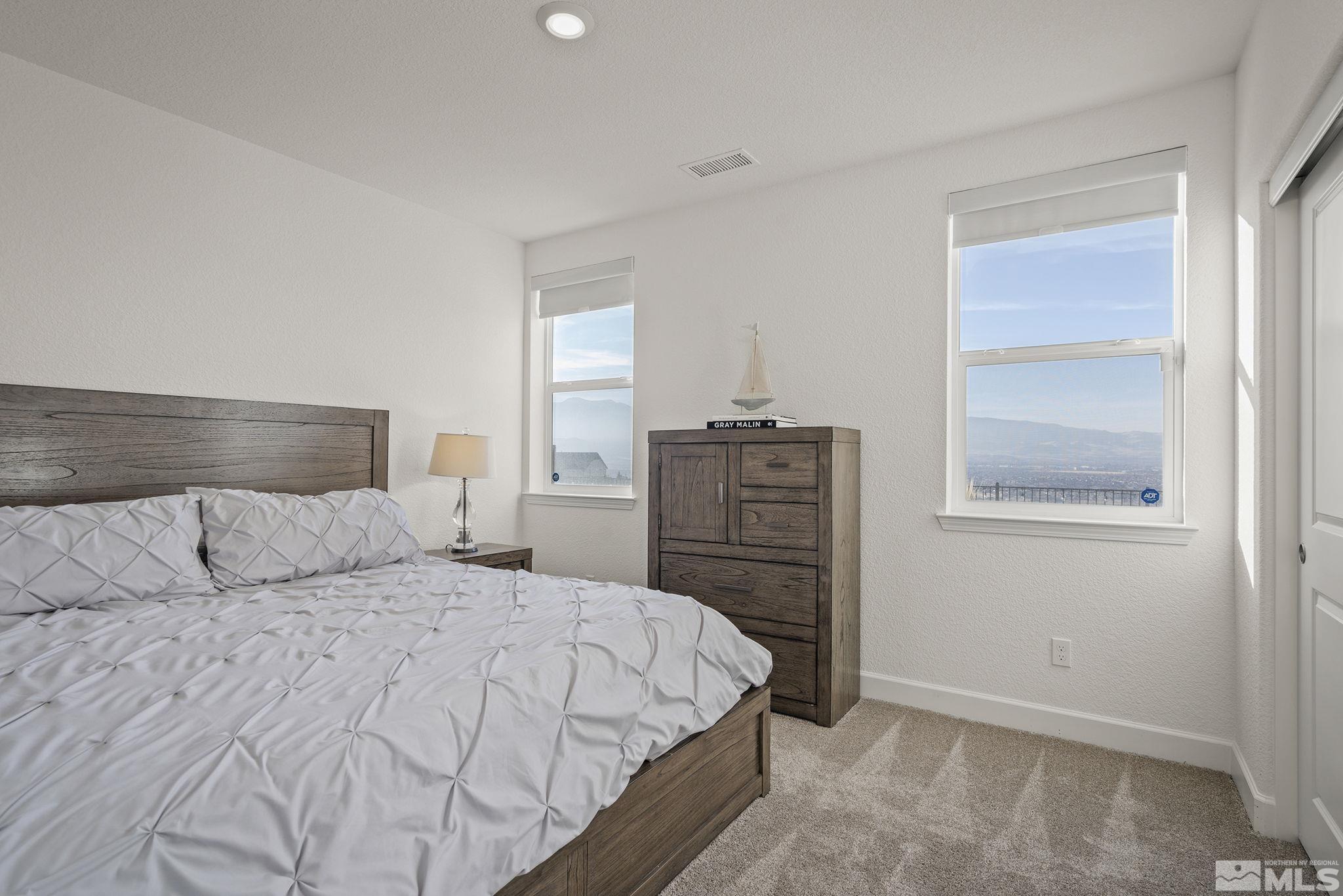 10489 Claim Jumper Way Reno, NV 89521 - Photo 24 of 40 a bedroom with a bed and cabinet