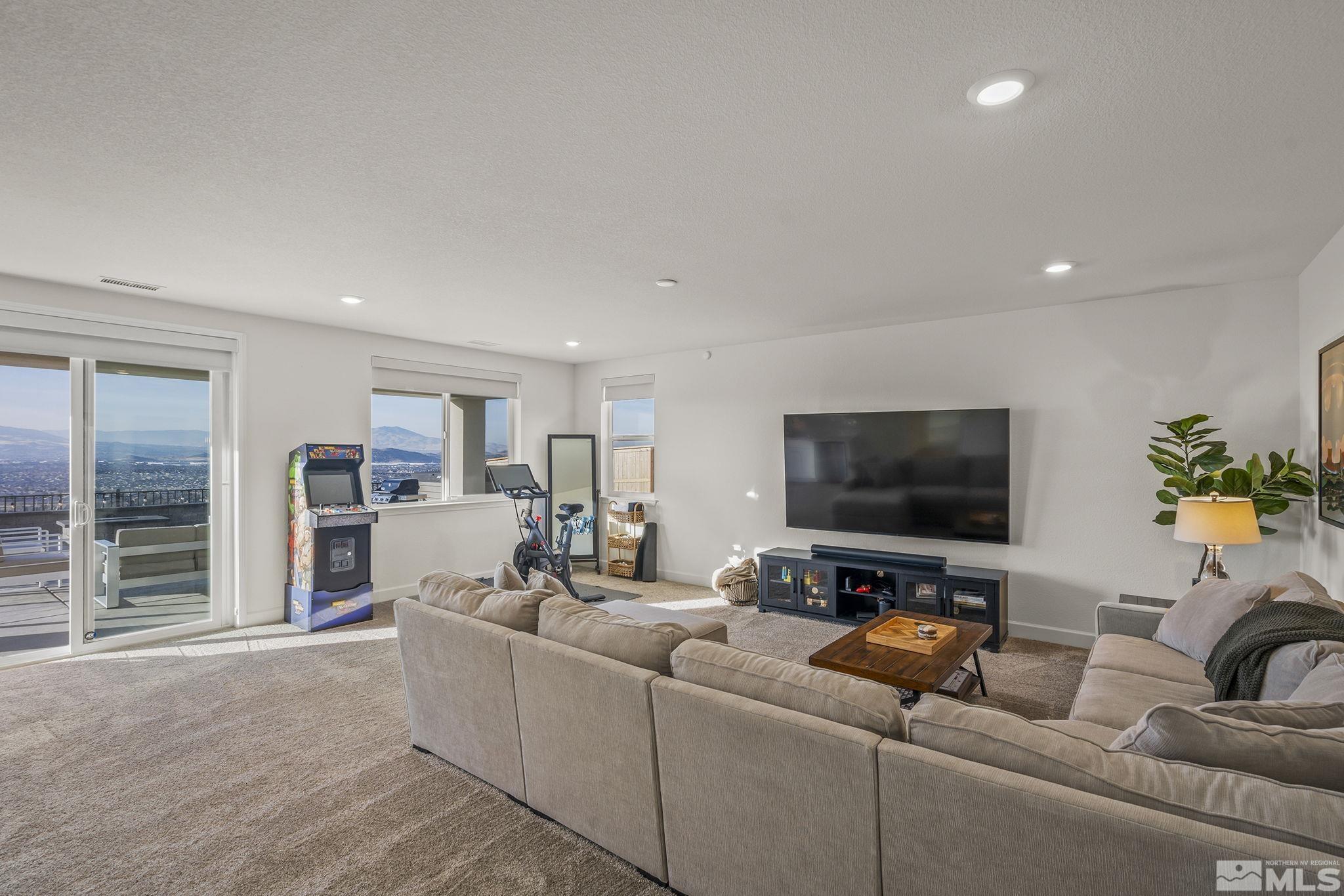 10489 Claim Jumper Way Reno, NV 89521 - Photo 29 of 40 a living room with furniture and a flat screen tv
