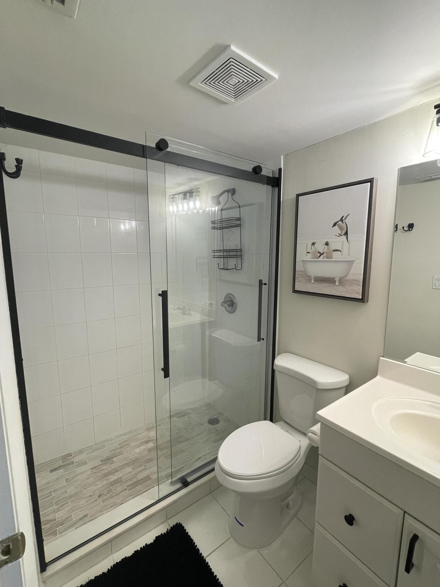 1605 Highway 1, Unit 201V2 Jupiter, FL 33477 - Photo 4 of 9 a bathroom with a toilet a sink and shower