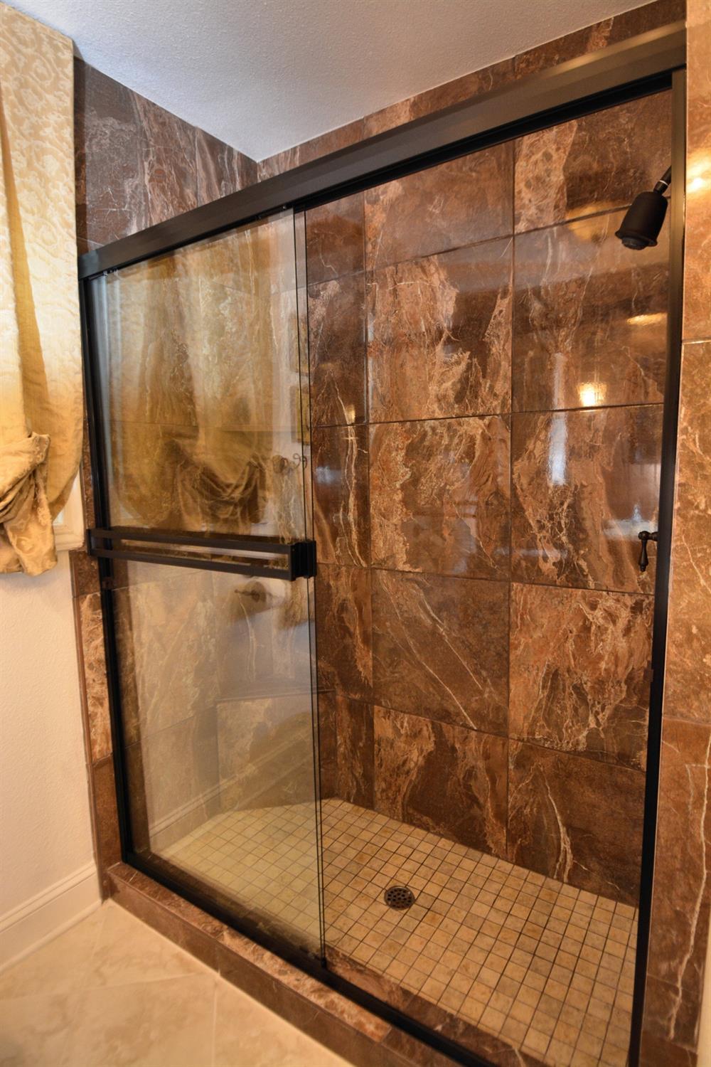 1306 Joni Avenue Modesto, CA 95350 - Photo 11 of 20 a bathroom with a glass shower door