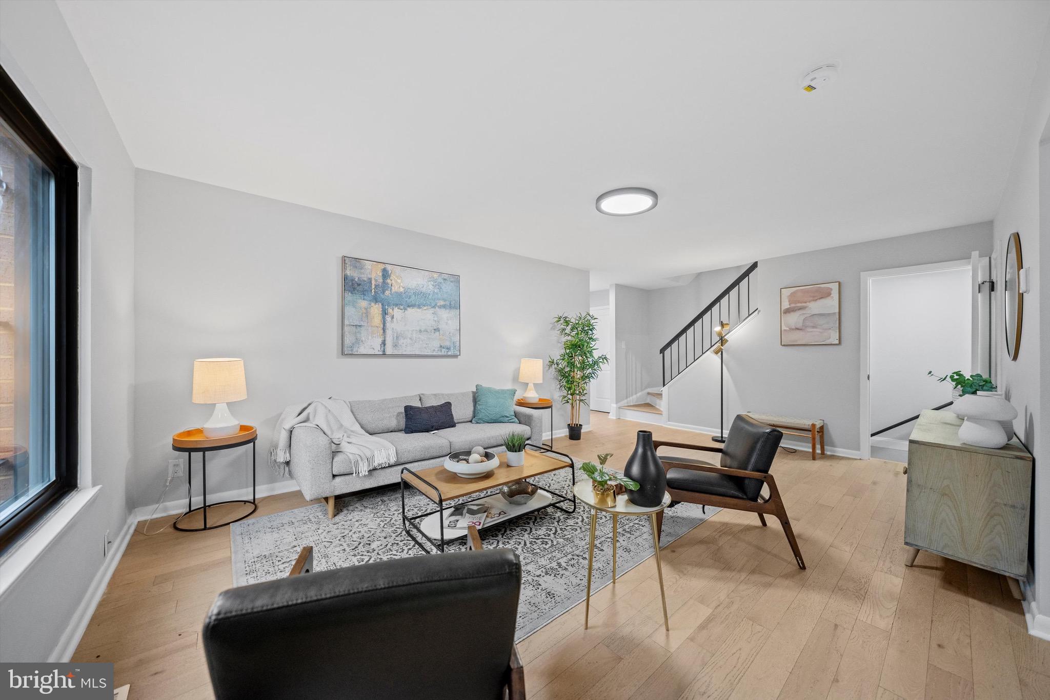 a living room with furniture and a potted plant