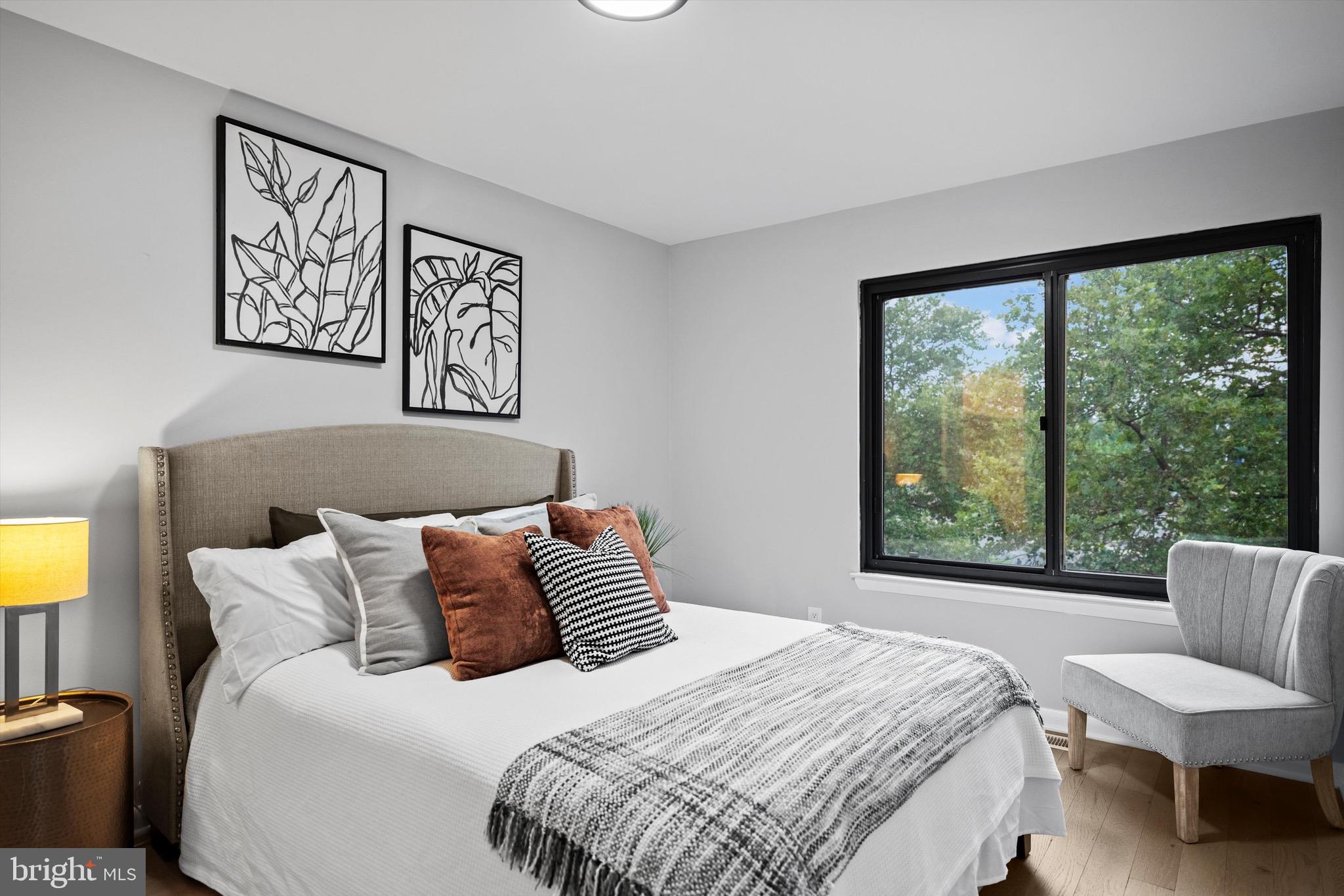 3114 Berry Road Northeast, Unit 21 Washington, DC 20018 - Photo 15 of 25 a bedroom with a bed and a large window