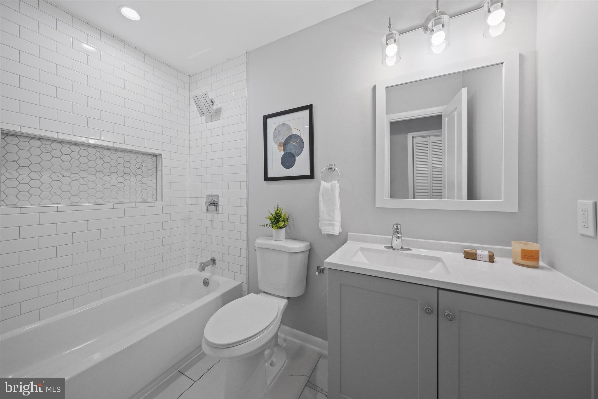 3114 Berry Road Northeast, Unit 21 Washington, DC 20018 - Photo 18 of 25 a bathroom with a sink a toilet and shower