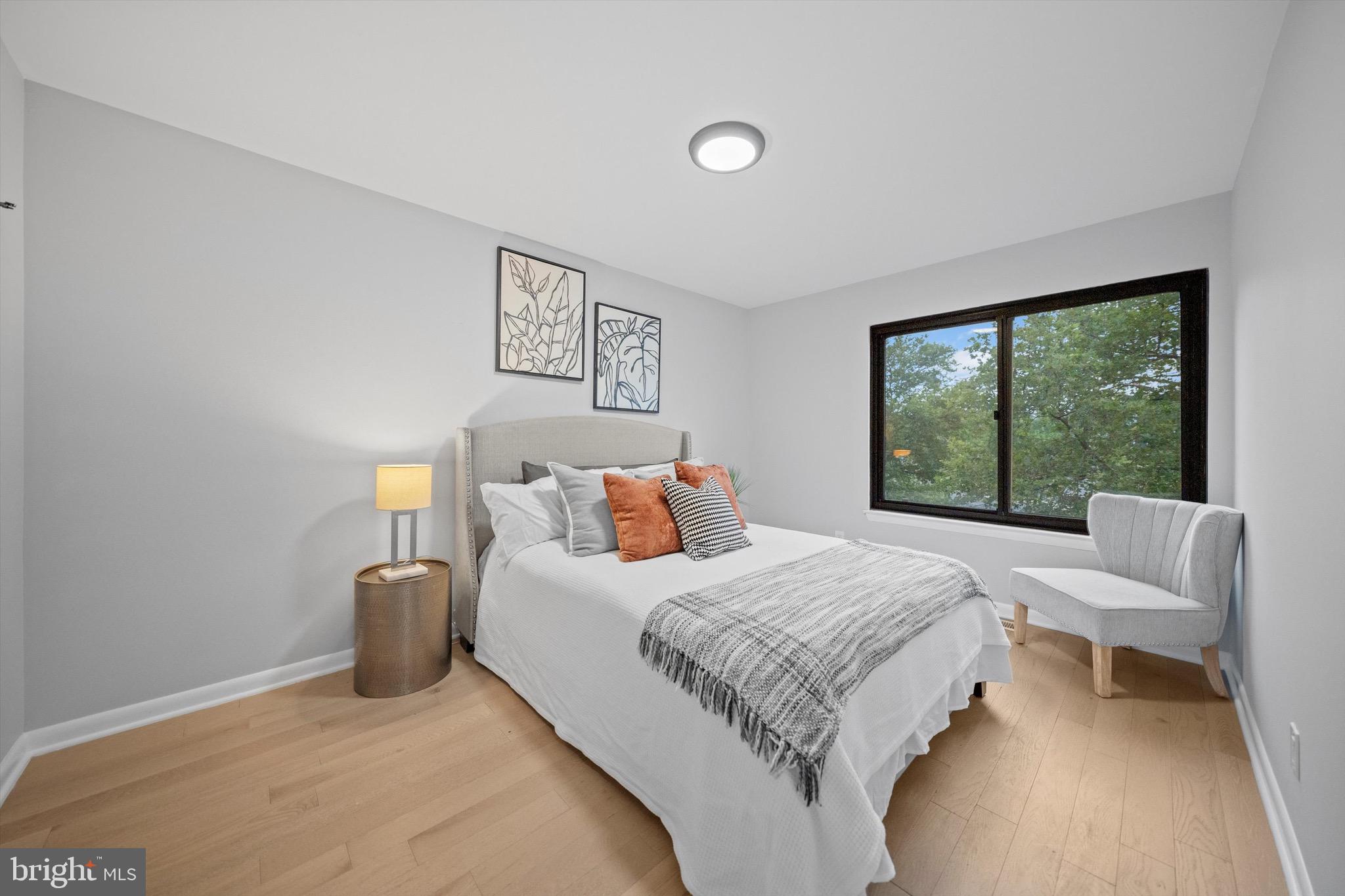 3114 Berry Road Northeast, Unit 21 Washington, DC 20018 - Photo 2 of 25 a bedroom with a bed and a large window